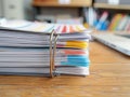 Stack of organized documents with colored tabs on a wooden desk with laptop background Royalty Free Stock Photo
