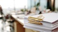 Stack of papers with golden paper clip in office setting Royalty Free Stock Photo