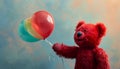 The red teddy bear\'s delight as it plays with a vibrant toy balloon Royalty Free Stock Photo