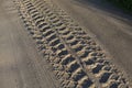 Close up shot of car tire tracks, prints and marks on a muddy dusty sand road surface Royalty Free Stock Photo