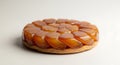 Close up of a caramelized apple tart tatin on a white surface in a studio lighting setting Royalty Free Stock Photo