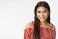 Close-up shot of charming cute and tender indian teenage girl in blouse with long dark natural hair smiling friendly at Royalty Free Stock Photo