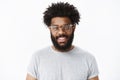 Close-up shot of charming pleasant and delighted dark-skinned bearded male customer in glasses with afro hairstyle in