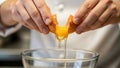Chef\'s hands cracking an egg into a glass bowl. Royalty Free Stock Photo