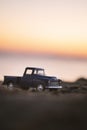 Close up shot of a Chevrolet 3100 pickup truck on sand and on sunset