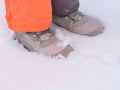 A closeup shot of child feet in winter shoes standing on snow Royalty Free Stock Photo