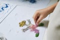 Hand creating funny art work with glitter