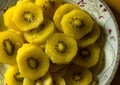 Close up shot of chopped Fresh golden kiwi fruit on a plate kept under soft light Royalty Free Stock Photo