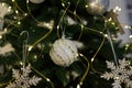 Close up shot of Christmas tree branch with bauble and wooden toys. Beautiful garland lights boke on background Royalty Free Stock Photo