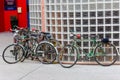 Close-up shot of classic bikes parked by a glass wall
