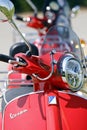 Vertical closeup of a Red Vespa motor-scooter