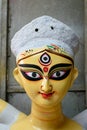 Close up shot of clay idol of Goddess Devi Durga, before upcoming Durga Puja at a potter`s studio in Kolkata Royalty Free Stock Photo