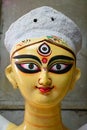 Close up shot of clay idol of Goddess Devi Durga, before upcoming Durga Puja at a potter`s studio in Kolkata Royalty Free Stock Photo
