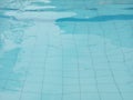 a close-up shot of the clear blue waters of a swimming pool.