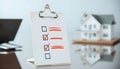 Real Estate Checklist with House Model and Laptop Royalty Free Stock Photo