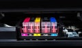 Close-up shot of a CMYK ink cartridges in a color printer. Royalty Free Stock Photo