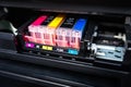 Close-up shot of a CMYK ink cartridges in a color printer. Royalty Free Stock Photo