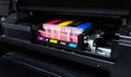 Close-up shot of a CMYK ink cartridges in a color printer. Royalty Free Stock Photo