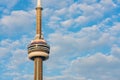 Close up shot of the CN Tower with clouds