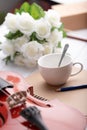 Close-up shot coffee cup violin orchestra instrumental over white wooden background select focus shallow depth of field Royalty Free Stock Photo