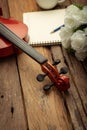 Close-up shot coffee cup and violin orchestra instrumental over wooden background select focus Royalty Free Stock Photo