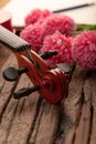 Close-up shot coffee cup and violin orchestra instrumental over wooden background select focus shallow depth of field Royalty Free Stock Photo