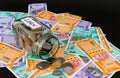 Close up shot of coin filled glass jar with money notes for bank loan concept