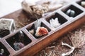 Close up shot of a collection of many different crystals on a messy wiccan witch`s altar, with blurred background