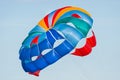 Close up shot of a colorful parachute used for parasailing pulled by a motorboat.