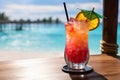 A close-up shot of a colorful tropical cocktail on a beachside bar