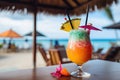 A close-up shot of a colorful tropical cocktail on a beachside bar