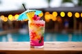 A close-up shot of a colorful tropical cocktail on a beachside bar