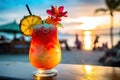 A close-up shot of a colorful tropical cocktail on a beachside bar