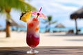 A close-up shot of a colorful tropical cocktail on a beachside bar