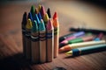 A close-up shot of colourful crayons on a wooden table with paper Royalty Free Stock Photo