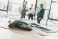 close-up shot of conference phone with blurred business people on background