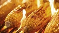 Close-up shot of corn on the cob roasting over an open fire, the kernels glistening with melted butter Royalty Free Stock Photo