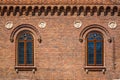 Close-up shot of cross hatch styled windows on a brick building in Krakow, Poland