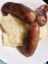 A close up shot of Cumberland Sausages served On Fluffy White Creamy Tarragon and Garlic Mashed Potato, Devon, UK Royalty Free Stock Photo
