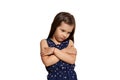 Close-up studio shot of beautiful brunette little girl posing isolated on white studio background. Royalty Free Stock Photo