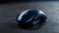 A close up shot of a dark blue wireless computer mouse on dark surface Royalty Free Stock Photo