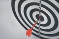 Close up shot of the dart arrow hit on bullseye, red dart arrow hitting in the target center of dartboard Target hit in the center Royalty Free Stock Photo