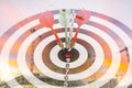 Close up shot of the dart arrow hit on bullseye, red dart arrow hitting in the target center of dartboard Target hit in the center Royalty Free Stock Photo