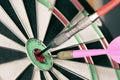 Close up shot of the dart arrow hitting on bull eyes of dartboard