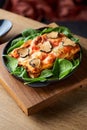 close up shot of a delicious gourmet slice of lasagna bolognese on a wooden board Royalty Free Stock Photo