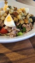 Close-up shot of delicious tuna salad served with fresh vegetable, tomatoe, olive and boiled eggs Royalty Free Stock Photo