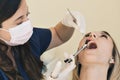 Close up shot of Dentist administering anesthesia to female patient