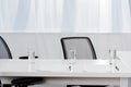 close-up shot of desk with glasses of water and blank papers