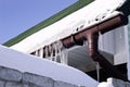 Close-up shot of a eavestrough at a standard roof. winter Royalty Free Stock Photo