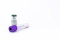 Close up shot of an  empty COVID 19 test sample collection tube with a medicine vial on white background Royalty Free Stock Photo